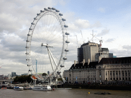 Boats in the Thames river, the London Eye and the County Hall, viewed from the Westminster Bridge