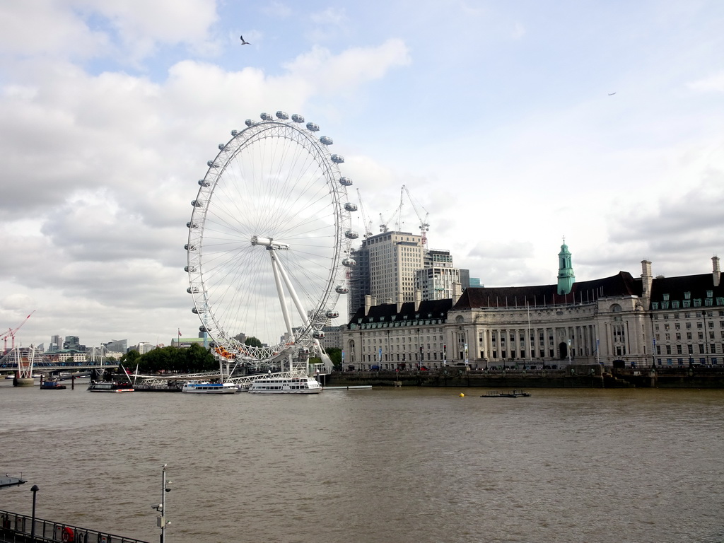 Boats in the Thames river, the Hungerford Bridge and Golden Jubilee Bridges, the London Eye and the County Hall, viewed from the Westminster Bridge