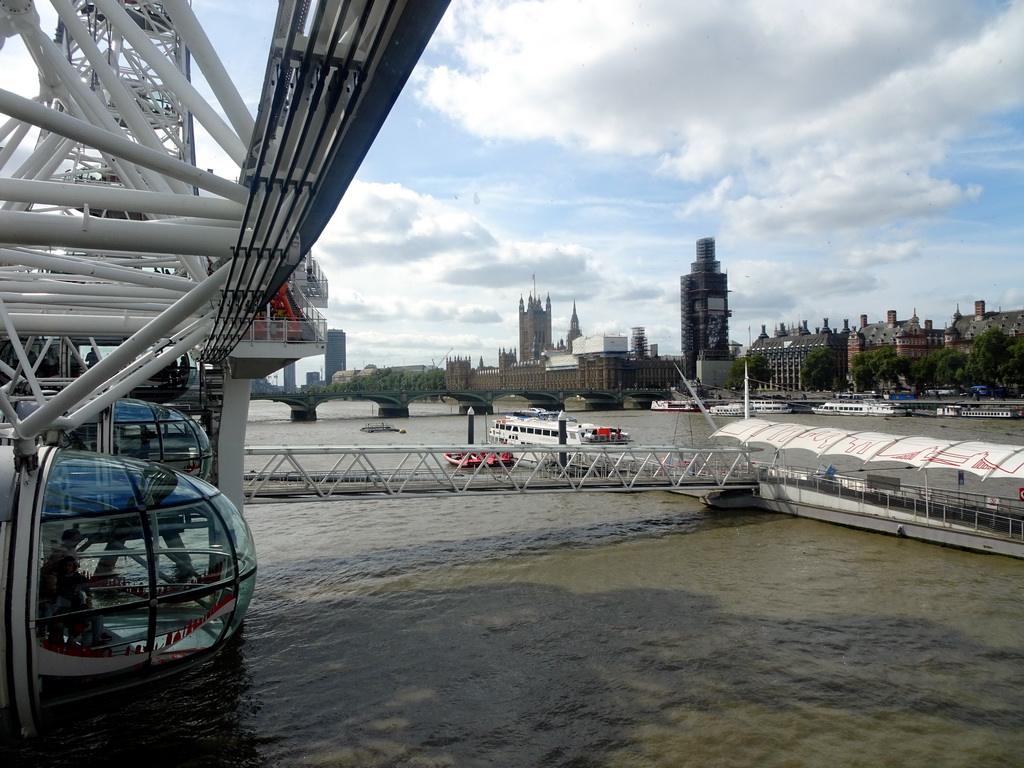 Bottom part of the London Eye, the London Eye Pier, the Westminster Bridge over the Thames river and the Palace of Westminster with the Big Ben, viewed from capsule 17 of the London Eye