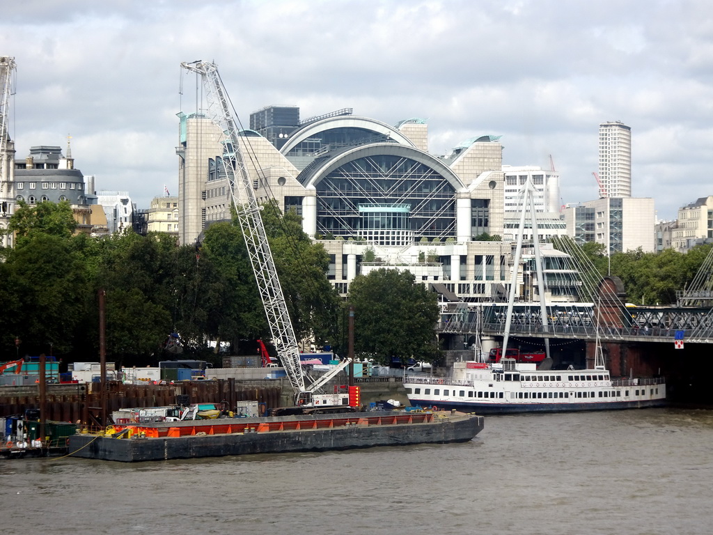 Boats in the Thames river, the Hungerford Bridge and Golden Jubilee Bridges and the Charing Cross Railway Station, viewed from capsule 17 of the London Eye