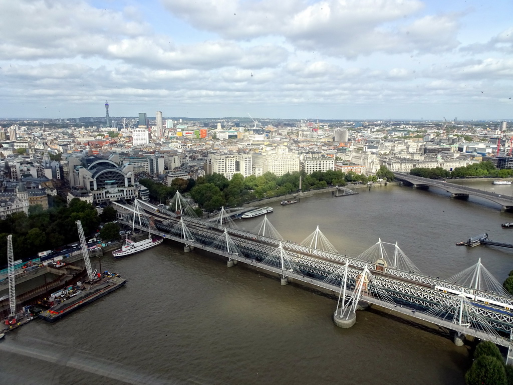Boats in the Thames river, the Hungerford Bridge, the Golden Jubilee Bridges, the Waterloo Bridge, the Charing Cross Railway Station and the BT Tower, viewed from capsule 17 of the London Eye