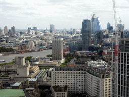 Boats in the Thames river, St. Paul`s Cathedral, the South Bank Tower, the One Blackfriars Road building and other skyscrapers in the city center, viewed from capsule 17 of the London Eye