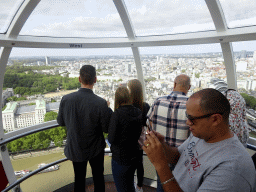 Interior of capsule 17 of the London Eye, with a view on boats in the Thames river, the Whitehall Gardens, the Ministry of Defence and St. James`s Park