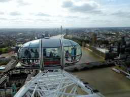 Capsule of the London Eye, boats in the Thames river, the Westminster Bridge, the Palace of Westminster with the Big Ben, the Vauxhall Bridge and the St. George Wharf Tower, viewed from capsule 17 of the London Eye