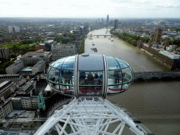 Capsule of the London Eye, boats in the Thames river, the Westminster Bridge, the Palace of Westminster, the County Hall, the Archbishop`s Park, the Lambeth Bridge, the Vauxhall Bridge and the St. George Wharf Tower, viewed from capsule 17 of the London Eye
