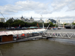 Boats and the London Eye Pier in the Thames river, the Hungerford Bridge, the Golden Jubilee Bridges and the Charing Cross Railway Station, viewed from capsule 17 of the London Eye