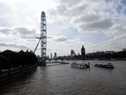 Boats in the Thames river, the London Eye, the Westminster Bridge, the Palace of Westminster with the Big Ben and the St. George Wharf Tower, viewed from the southern Golden Jubilee Bridge