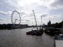 Boats in the Thames river, the London Eye, the Westminster Bridge and the Big Ben of the Palace of Westminster, viewed from the southern Golden Jubilee Bridge