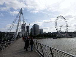 The southern Golden Jubilee Bridge and the Hungerford Bridge over the Thames river, and the London Eye