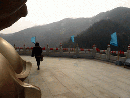 Miaomiao at the back side of the Nanshan Great Buddha, with a view on the surrounding hills