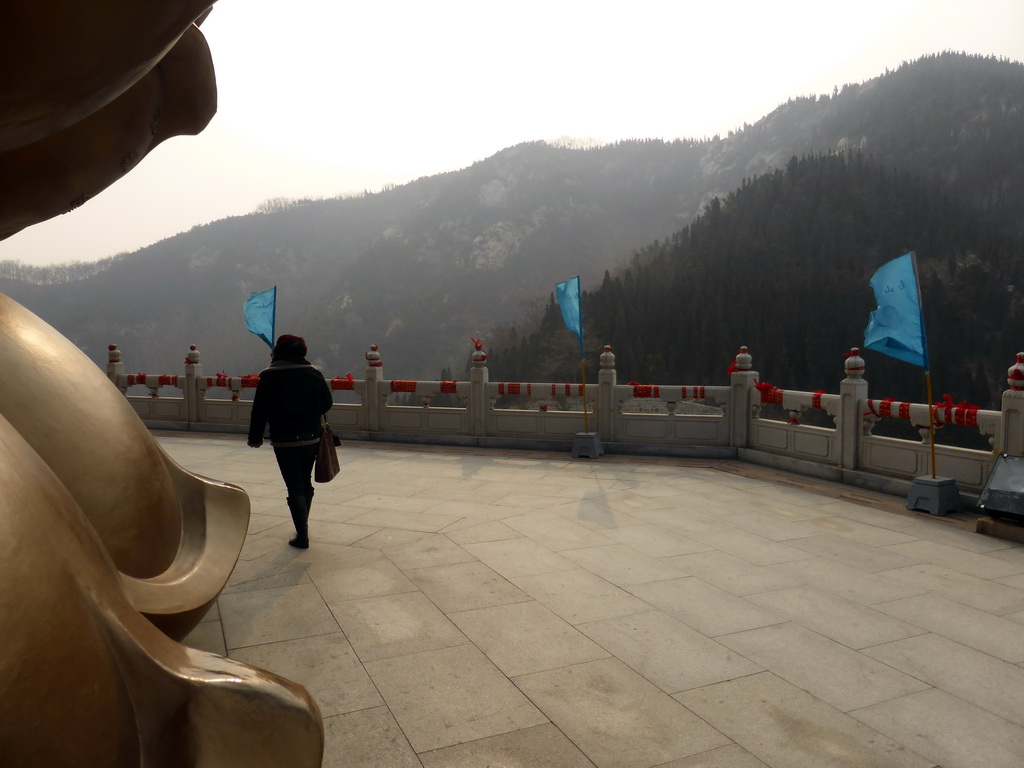 Miaomiao at the back side of the Nanshan Great Buddha, with a view on the surrounding hills