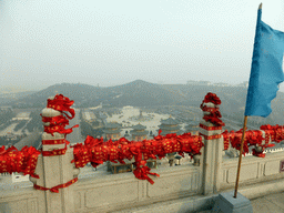 Flag and decorations at the north side of the highest platform at the Nanshan Great Buddha, with a view on the eastern side of the Nanshan Temple