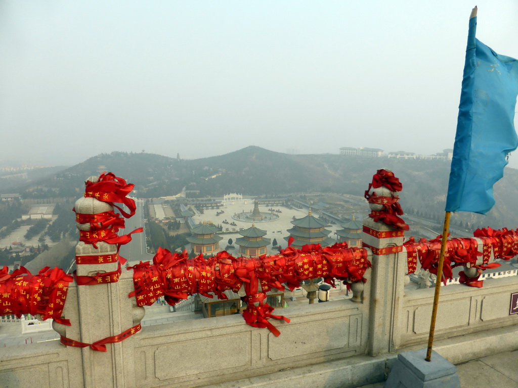 Flag and decorations at the north side of the highest platform at the Nanshan Great Buddha, with a view on the eastern side of the Nanshan Temple