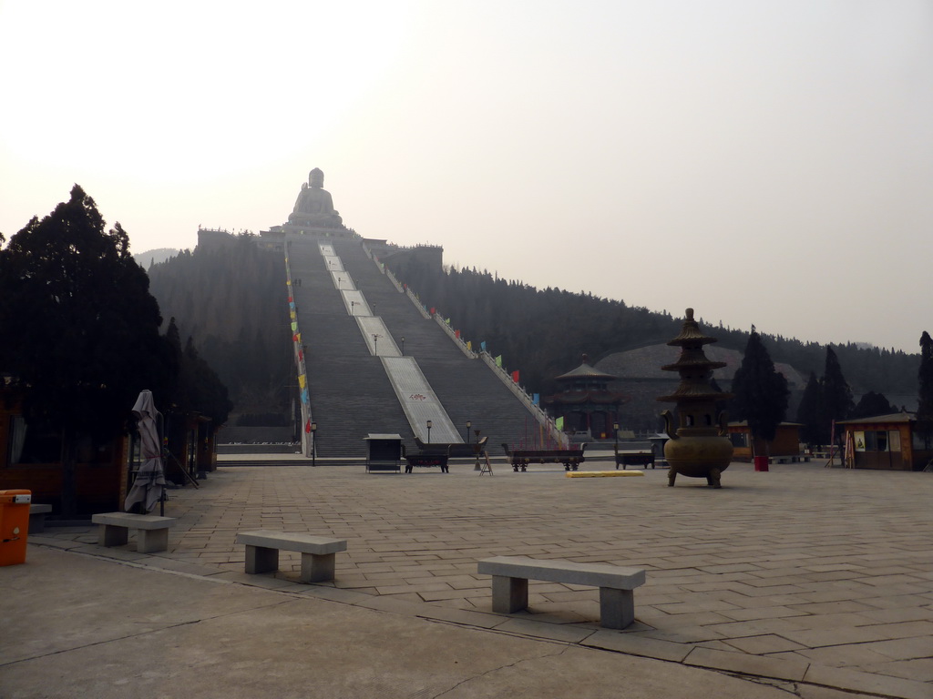 Incense burner at the central square of the Nanshan Temple, and the Nanshan Great Buddha with its staircase