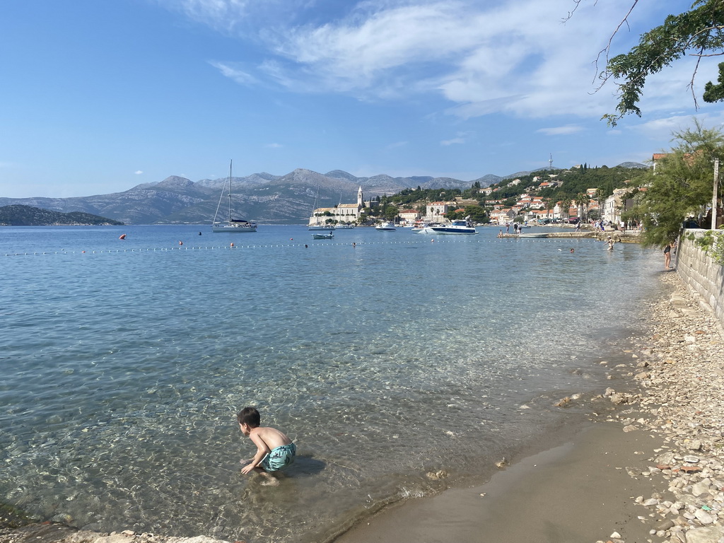 Max at the Plaa Grand beach, with a view on boats at the Lopud Harbour, the Plaa Dubrava Pracat beach, the Church of Sveta Marija od pilice and Ruda island