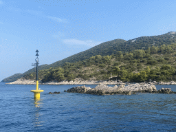 Buoy and cross at the Ruda island, viewed from the Elaphiti Islands tour boat