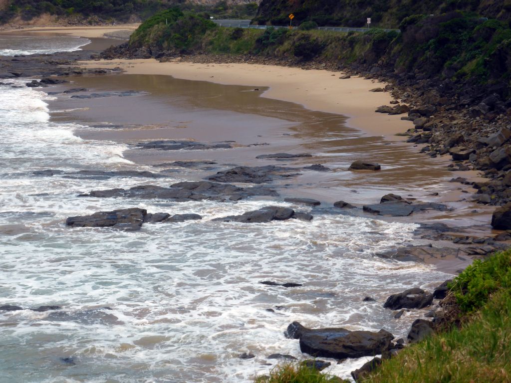 Beach at the coastline at the Cumberland River Holiday Park, viewed from a viewing point next to the Great Ocean Road