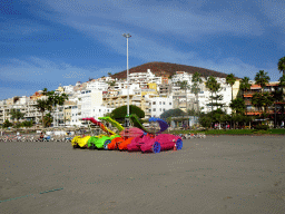 Plastic cars with slides on the Playa de Los Cristianos beach, the Avenida Juan Alfonso Batista street and the Chayofita Mountain