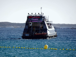 Boat leaving the Puerto de Los Cristianos harbour, viewed from the Playa de Los Cristianos beach