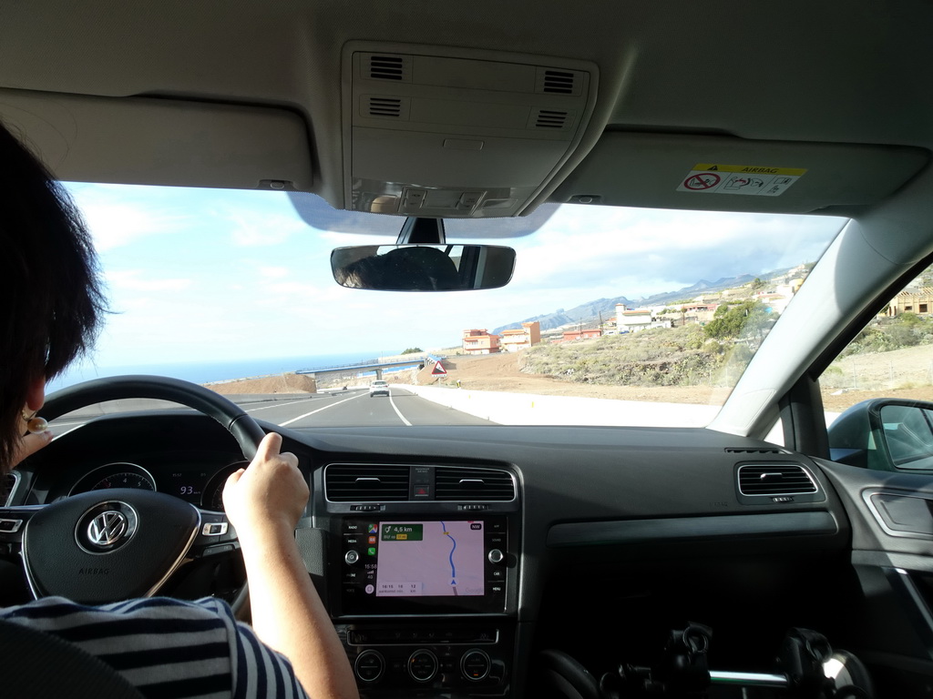 Miaomiao in the rental car, with a view on the TF-46 road near the town of Piedra Hincada