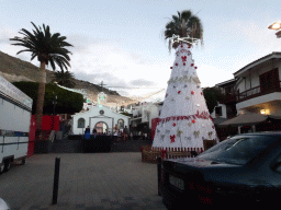 Christmas tree in front of the Parroquia del Espìritu Santo church at the Pasaje el Tarajal street, viewed from the rental car, at sunset