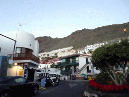 Buildings at the Calle Flor de Pascua street, viewed from the rental car, at sunset