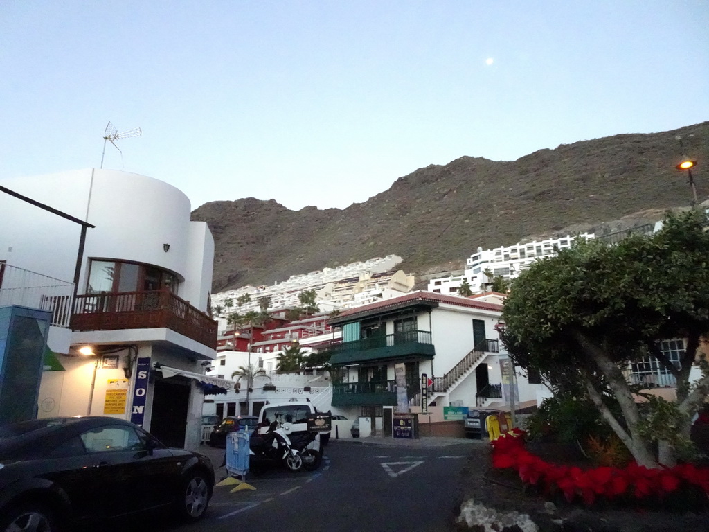 Buildings at the Calle Flor de Pascua street, viewed from the rental car, at sunset