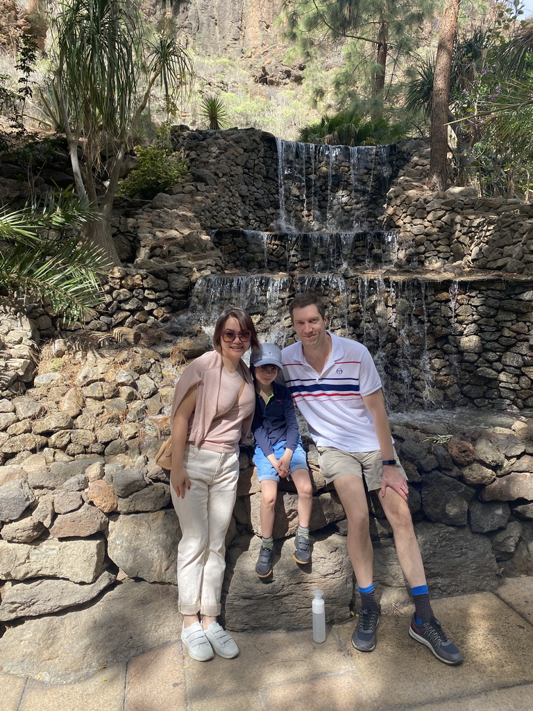 Tim, Miaomiao and Max in front of a waterfall at the entrance path to the Palmitos Park