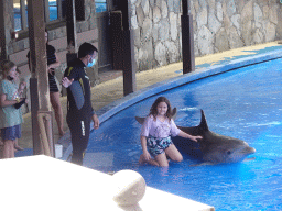 Zookeeper and visitors making photos with a Dolphin at the Dolphinarium at the Palmitos Park, just before the Dolphin Show