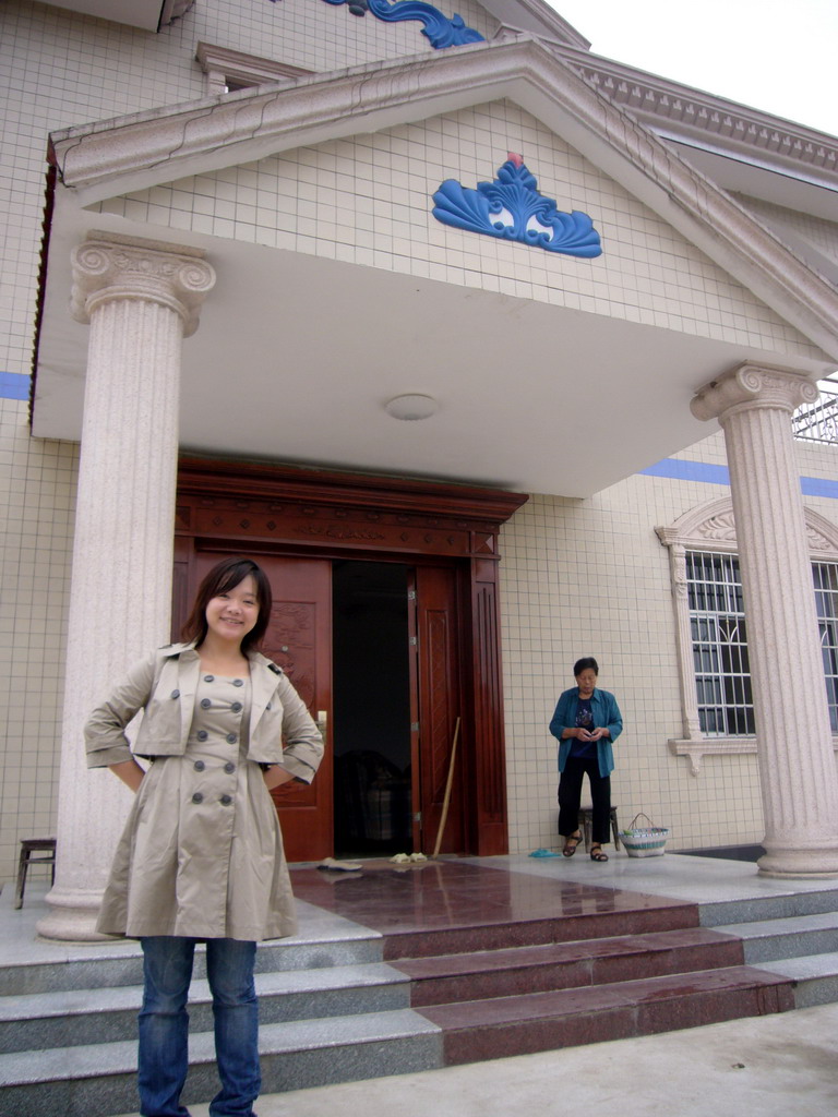 Miaomiao and her grandmother in front of her grandparents` house