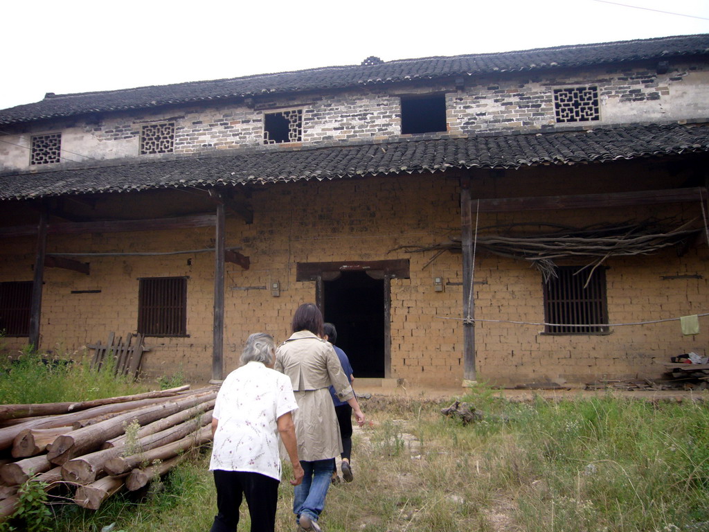 Miaomiao, her grandmother and a villager at the former primary school of Miaomiao`s grandparents` village