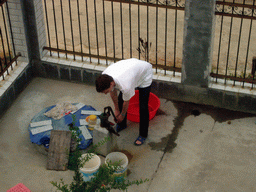 Tim getting water in front of Miaomiao`s grandparents` house, viewed from the roof