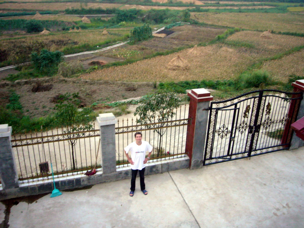 Tim in front of Miaomiao`s grandparents` house, viewed from the roof