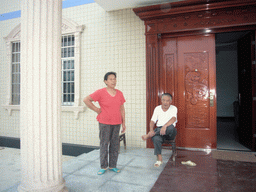 Miaomiao`s grandparents in front of their house