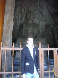 Tim with Buddha statue in the Qianxi Temple at the Longmen Grottoes