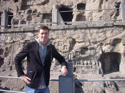 Tim at niches with small Buddha statues at the Longmen Grottoes
