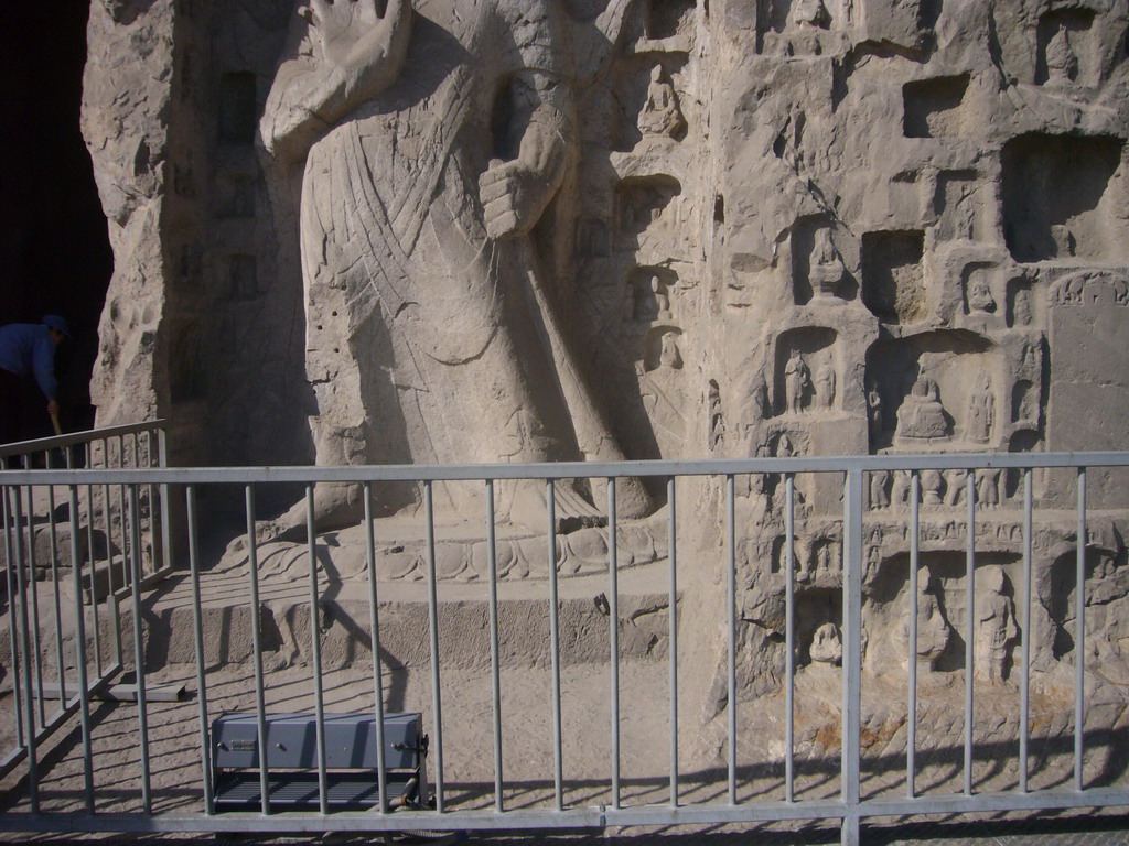 Statue and niches with small Buddha statues at the Longmen Grottoes