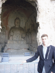 Tim with Buddha statue in Binyang South Cave at the Longmen Grottoes