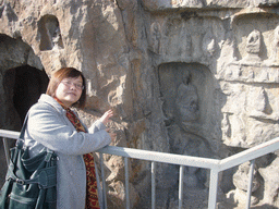 Miaomiao at niches with small Buddha statues at the Longmen Grottoes
