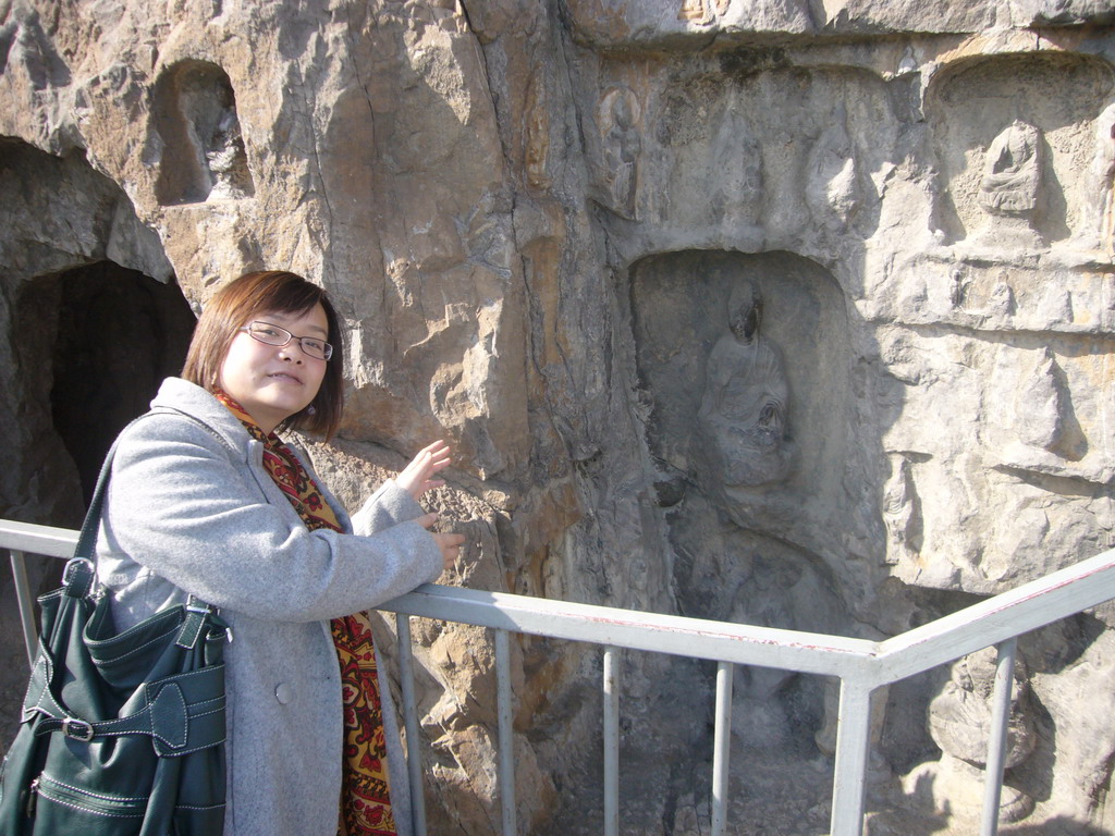 Miaomiao at niches with small Buddha statues at the Longmen Grottoes