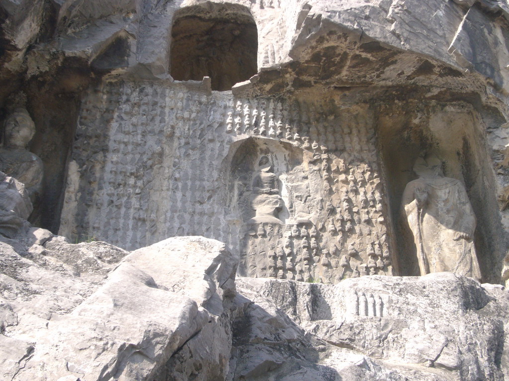 Wall with many small Buddha statues at the Longmen Grottoes