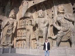 Tim with statues at Fengxian Temple at the Longmen Grottoes
