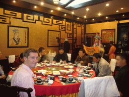 Tim watching a ritual being performed in a restaurant near Luoyang