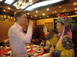 Tim getting a drink as part of a ritual being performed in a restaurant near Luoyang