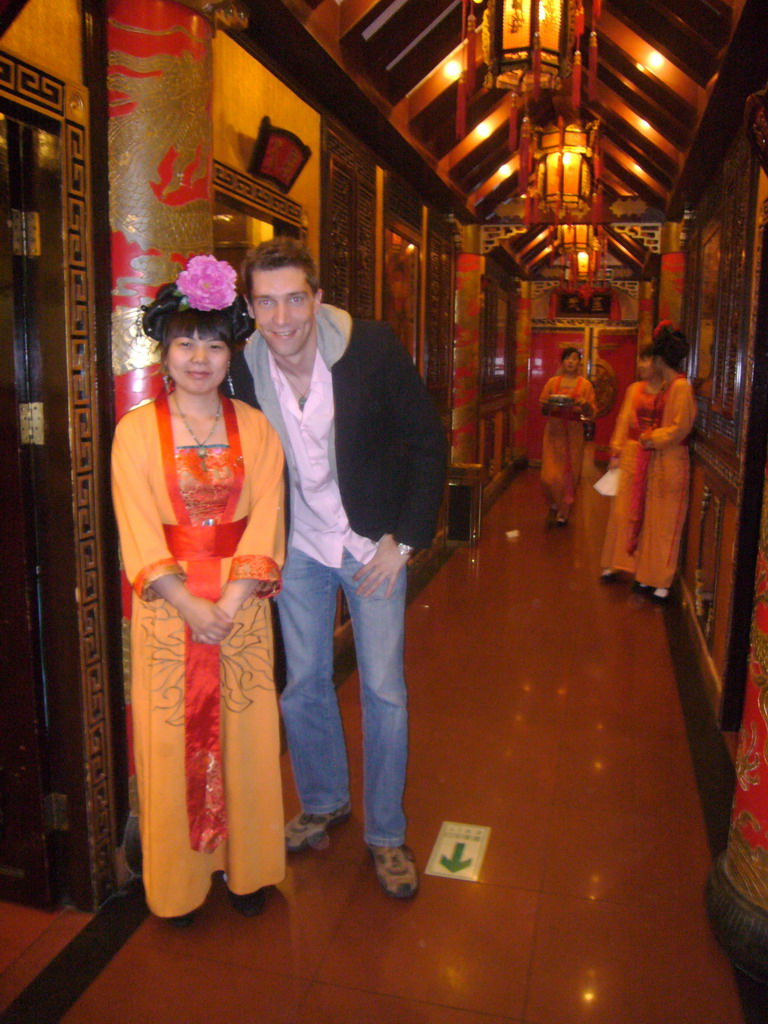 Tim with waitresses in a restaurant near Luoyang