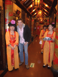 Tim with waitresses in a restaurant near Luoyang