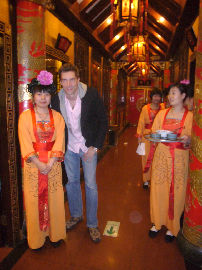 Tim with waitresses in a restaurant near Luoyang