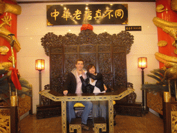 Tim and Miaomiao on a throne in a restaurant near Luoyang