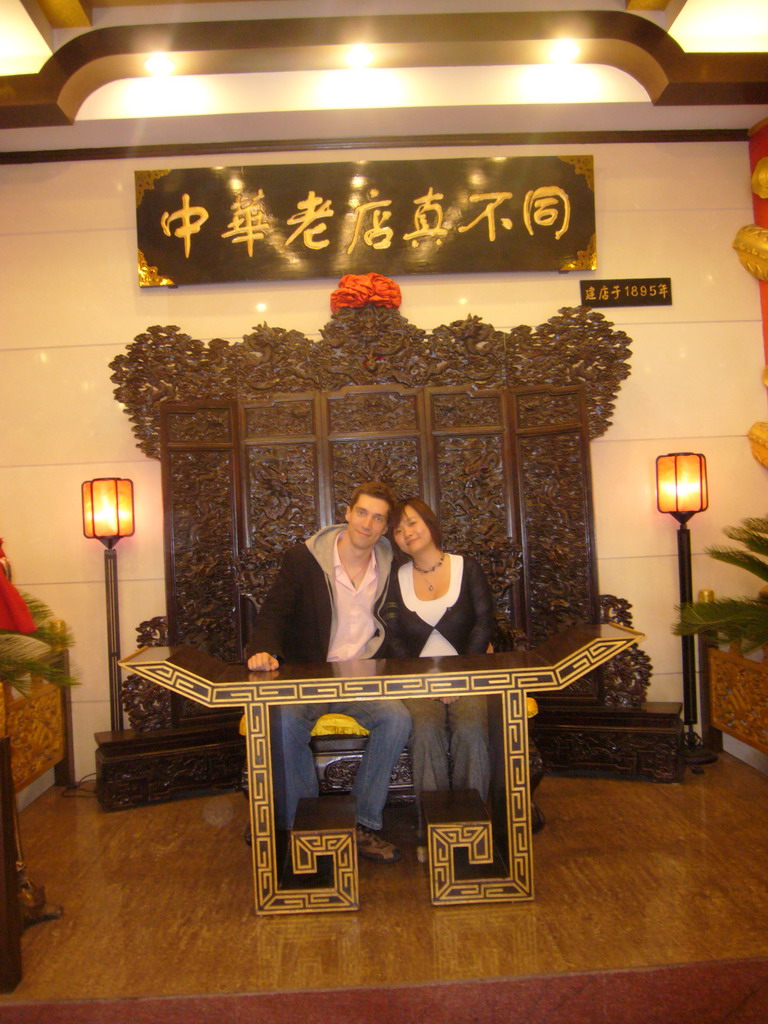 Tim and Miaomiao on a throne in a restaurant near Luoyang