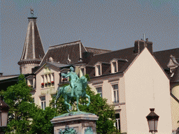 The statue of King William II of the Netherlands at the Place Guillaume II square and the tower of the Cercle Municipal building